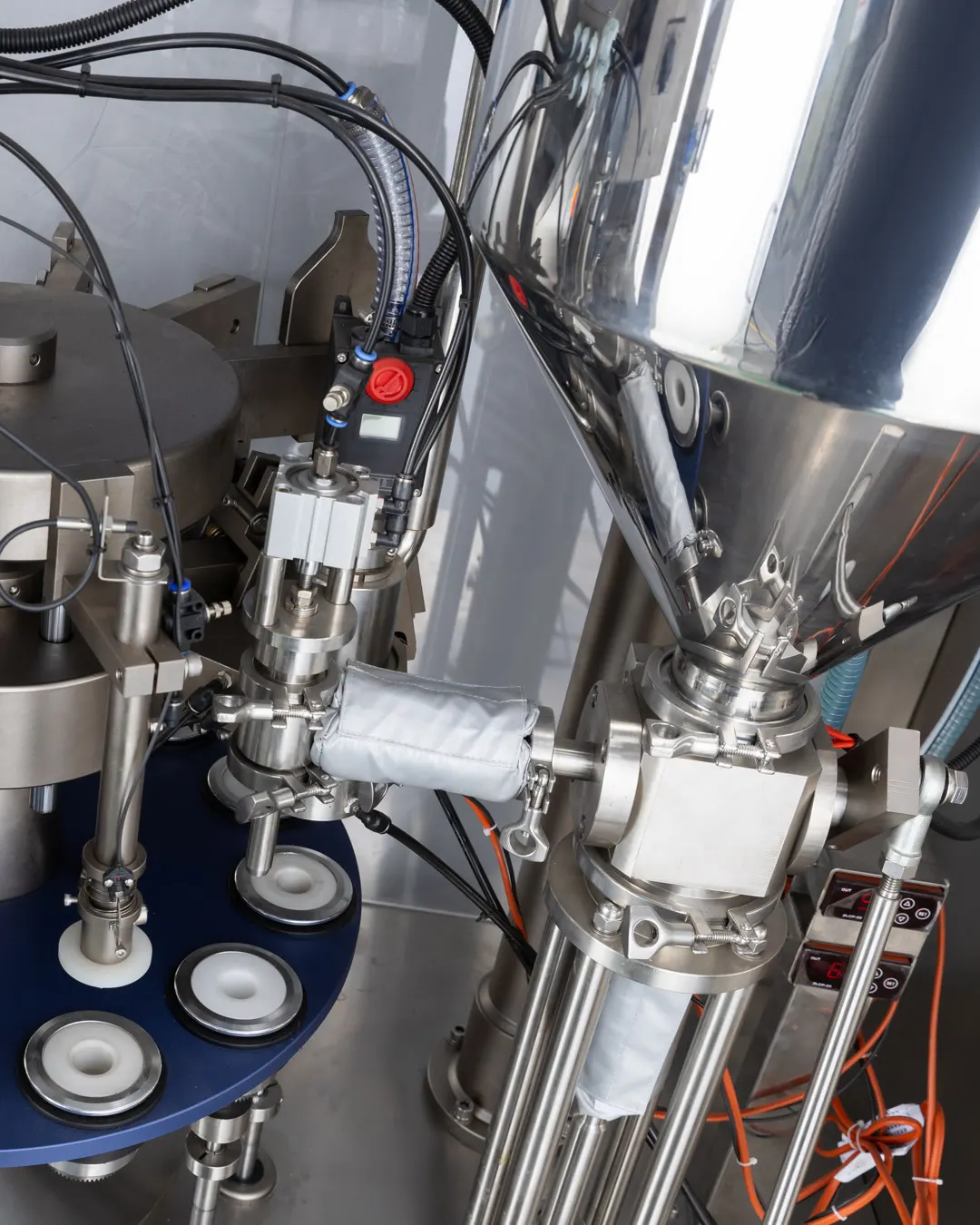 Veterinary ointment filling station with containers on the production line